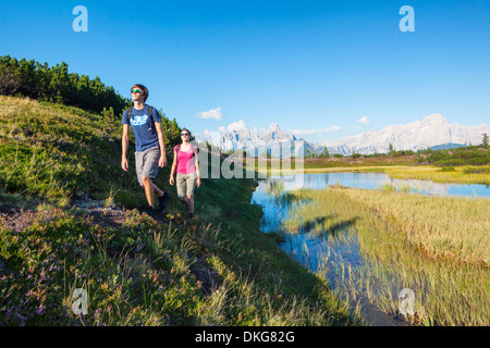 Young couple hiking, Bischofsmuetze, Gosaukamm und Dachstein, Salzburger Land, Austria, Europe Stock Photo