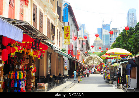 Shoppers walking through Chinatown street in Singapore Stock Photo