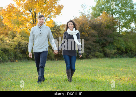 Smiling couple walking in autumn Stock Photo