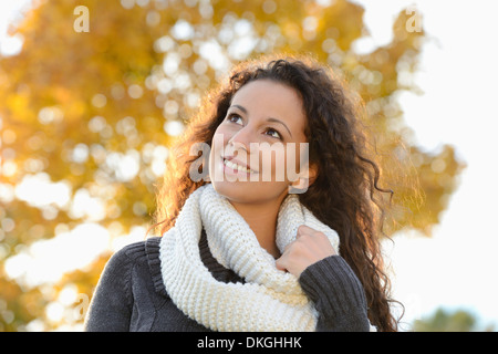 Smiling young woman in autumn Stock Photo