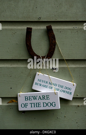 upside down horseshoe good luck symbol beware of the dog sign humour humorous humor garden shed gardening dillon garden Stock Photo