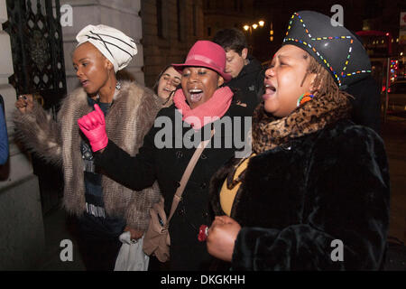 South Africa House, London, December 5th 2013. Women sing uplifting songs as people come to pay their respects at the South African embassy in London following the death of Nelson Mandela. Credit:  Paul Davey/Alamy Live News Stock Photo