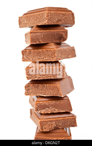 Chunks of Chocolate piled up in front of a white background. Stock Photo