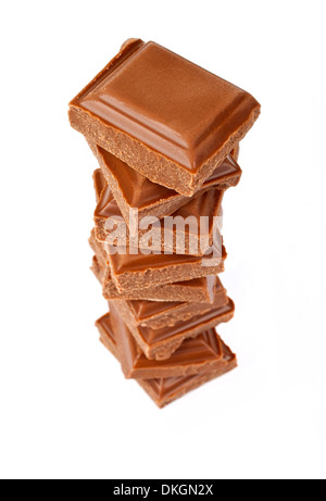 Chunks of Chocolate piled up in front of a white background. Stock Photo