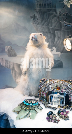 a white hamster against mythic diorama presents grouping of fabulous faux jewelled gifts in Bergdorf Goodman Christmas window Stock Photo