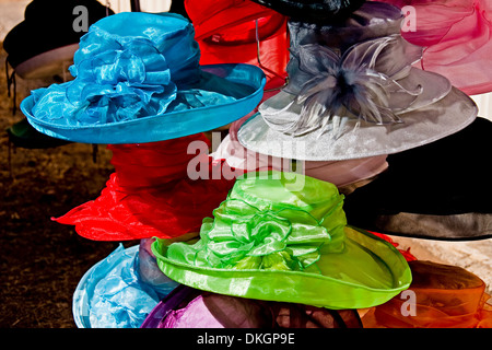Brightly coloured and decorative women's hats at street market stall in city of Maryborough Queensland Australia Stock Photo