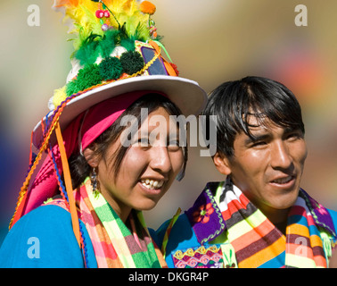 Portrait of happy young indigenous couple wearing colourful costumes in street fiesta in La Paz, Bolivia Stock Photo