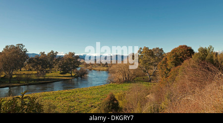Murray River through landscape of woodlands with snow capped peaks of Snowy Mountains on horizon near Corryong NSW Australia Stock Photo
