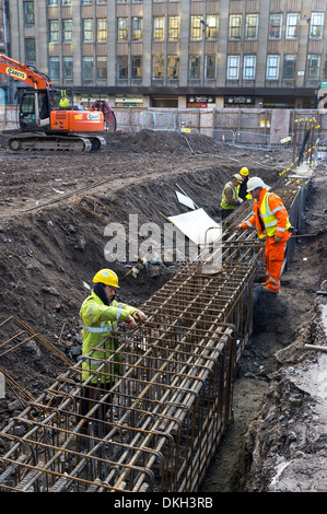 Workmen preparing the structure for concrete building foundations, Glasgow, Scotland, UK Stock Photo
