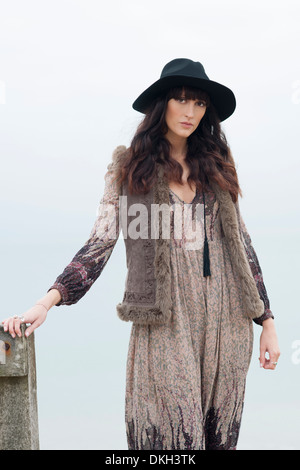 Portrait of young woman wearing boho clothes standing outdoors against  wooden door in old town Stock Photo - Alamy