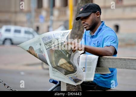 Pretoria, South Africa. 6th December 2013. A man reading of Madiba's death at Church Square, on December 6, 2013 in Pretoria, South Africa. The Father of the Nation, Nelson Mandela, Tata Madiba, passed away quietly on the evening of December 5, 2013 at his home in Houghton with family. (Photo by Gallo Images / Foto24 / Herman Verwey) Credit:  Gallo images/Alamy Live News Stock Photo