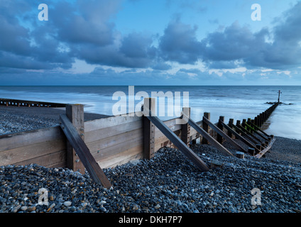 Sea defenses on the pebbly beach at Sheringham, Norfolk, England, United Kingdom, Europe Stock Photo