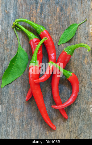 Red chili peppers over wooden background Stock Photo