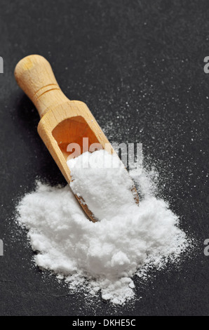 Wooden shovel with sodium bicarbonate on black background Stock Photo