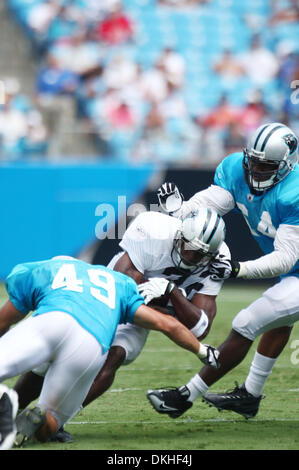 Aug. 8, 2009 - Charlotte, North Carolina, U.S - August 8, 2009:  Carolina Panther rookie running back Mike Goodson #33 is tackled by linebacker Jeremy Leman #49 during scrimmage at the Fan Fest held at Bank of America Stadium in Charlotte, North Carolina. (Credit Image: © Southcreek Global/ZUMApress.com) Stock Photo