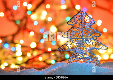 silver wired christmas tree on background with Christmas lights Stock Photo