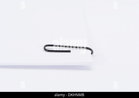 A Paper Clip on Sheets Of Plain Paper Stock Photo