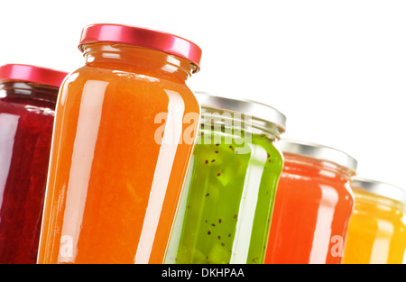 Jars of fruity jams isolated on white background. Preserved fruits Stock Photo