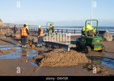 Roker Sunderland, Tyne and Wear, UK . 06th Dec, 2013. Following 60 year high tide last night workmen clearing sand and debris from the promenade at Roker in Sunderland, Tyne and Wear, England 6-12-13 Credit:  Washington Imaging/Alamy Live News