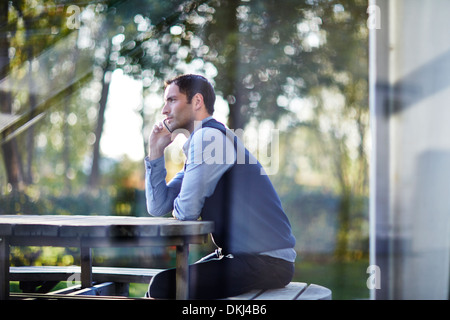 Businessman talking on cell phone outside Stock Photo
