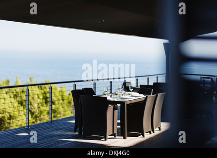 Dining table and chairs on modern balcony Stock Photo