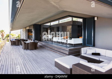 Sofa, tables and chairs on modern balcony Stock Photo