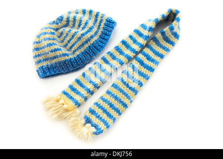 Blue and yellow striped hand knit wooly scarf and matching hat isolated on a white background Stock Photo