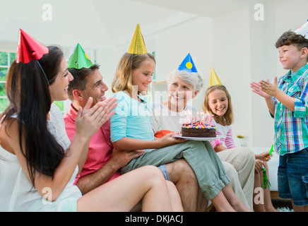 Family celebrating older womans birthday Stock Photo