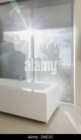 Sun shining through bathroom window Stock Photo