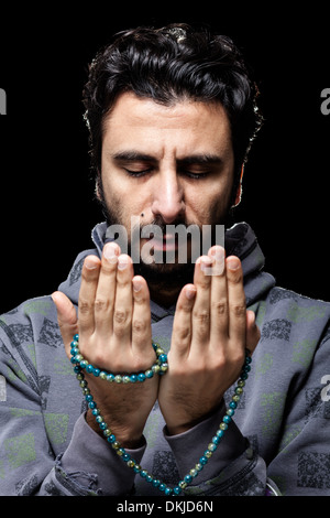 Western Muslim Praying with Tasbih Stock Photo