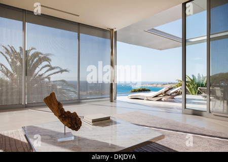 Modern living room and patio overlooking ocean Stock Photo