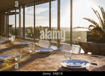 Set table in modern dining room Stock Photo