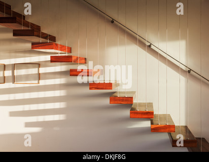 Shadows on floating staircase in modern house Stock Photo