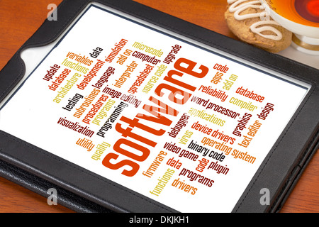 software and computer program word cloud on a digital tablet with a cup of tea Stock Photo
