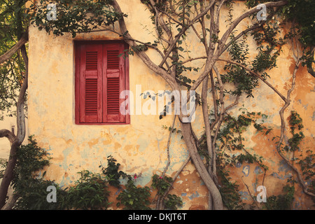 window with red shutter of Anafiotika in town of Athens,Greece.Vintage style. Stock Photo
