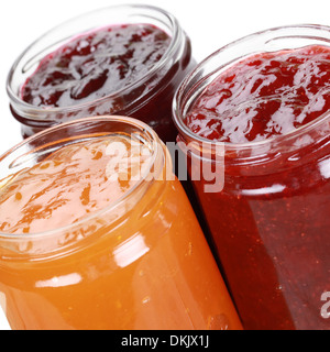 Marmalade made from strawberries, cherries and apricots in jars, isolated on white Stock Photo