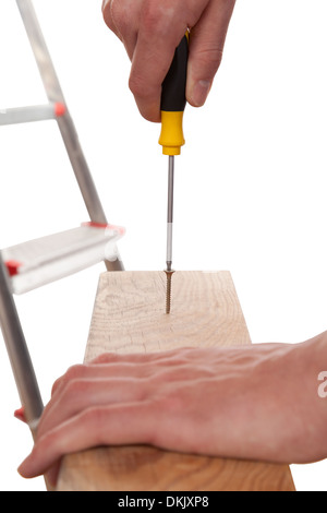 Carpenter holding a screwdriver in his hand, isolated on white Stock Photo