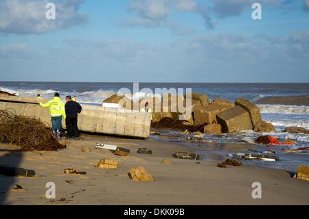 Hemsby, Norfolk, UK. 6th December 2013. The largest tidal surge since 1953 hits Hemsby overnight & caused damage to the sand dunes undermining the foundations of 5 homes along the Marrams and tipping them into the sea. The old lifeboat station was washed away in the tidal surge Credit:  East Anglian Picture Service/Alamy Live News Stock Photo