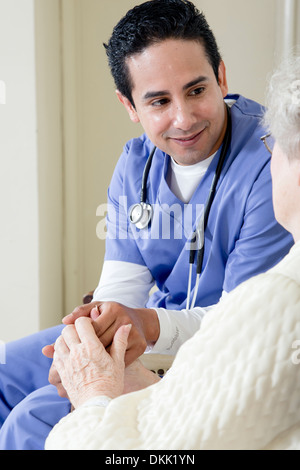 Male nurse assisting elderly patient Stock Photo
