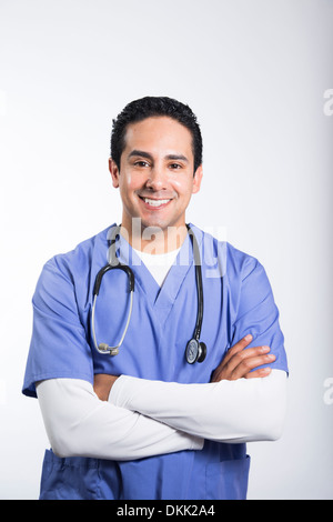 Smiling male nurse with arms crossed Stock Photo