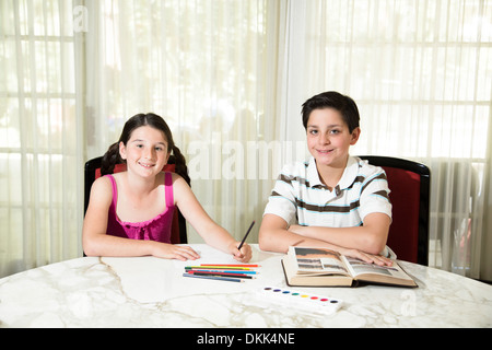Brother and sister doing homework Stock Photo