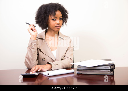 Young African American woman at a desk with binders Stock Photo