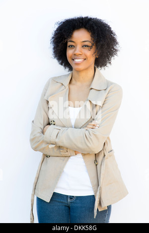 African American woman standing against a white background Stock Photo