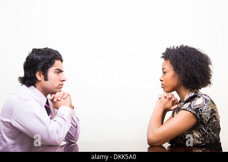 Young Indian business man and woman staring at each other Stock Photo