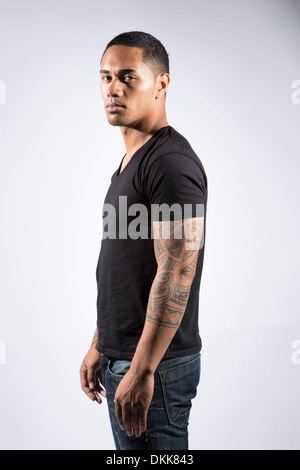Young tattooed man posing on white background Stock Photo