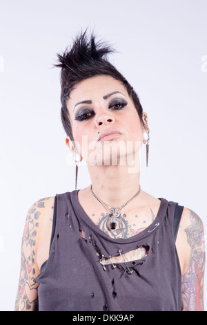 Tattooed punk girl posing on white background Stock Photo - Alamy