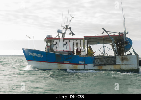 A scallop fishing boat ready to descend its dredges Stock Photo