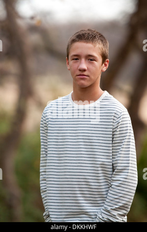Sad handsome teen outdoors looking depressed Stock Photo