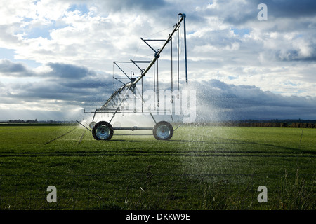 Irrigation booms spray water onto a pasture on the South Island of New Zealand Stock Photo