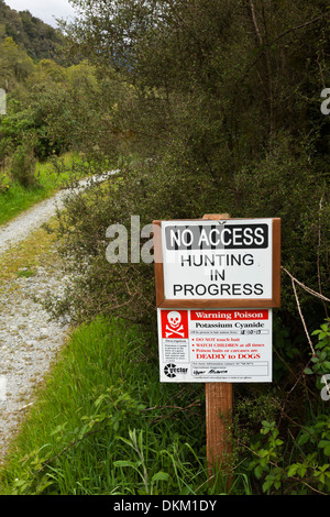 Hunting and Possum poisoning sign on roadway on a rural New Zealand  South Island farm Stock Photo